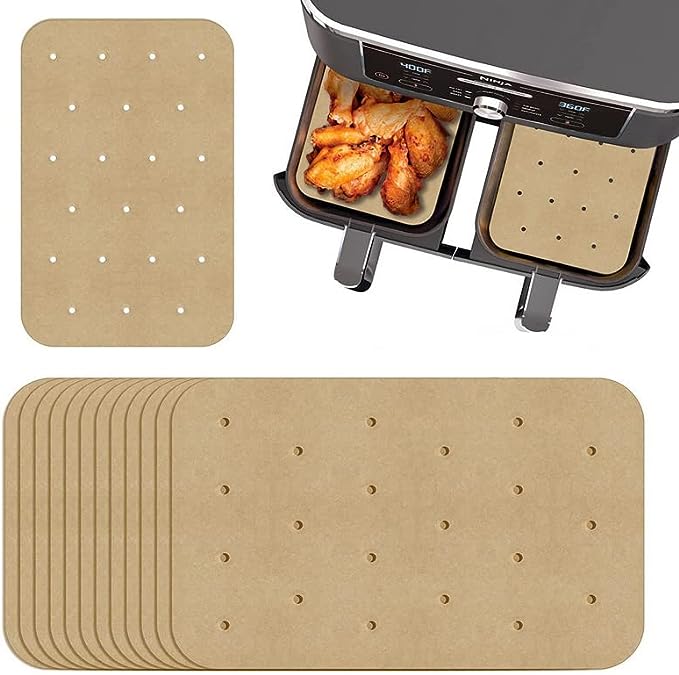 perforated paper air fryer liners inside an air fryer drawer